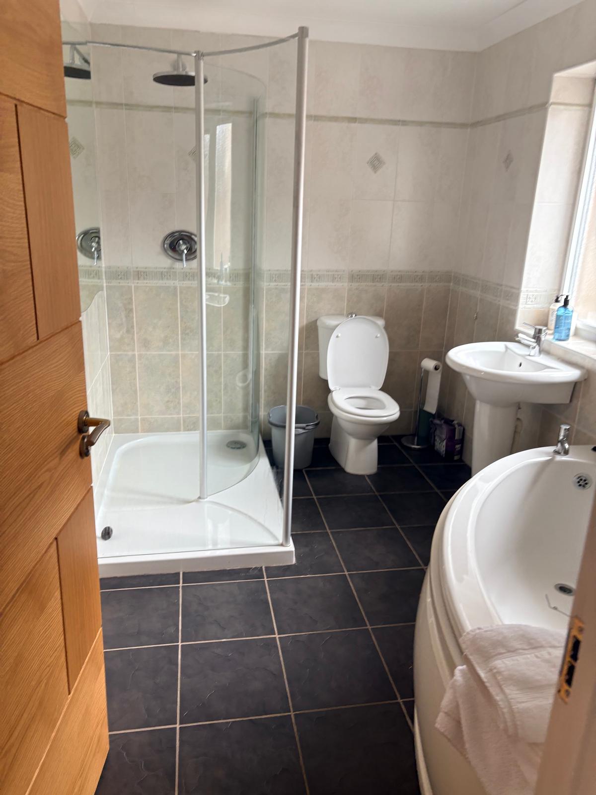 Family bathroom with corner bath
